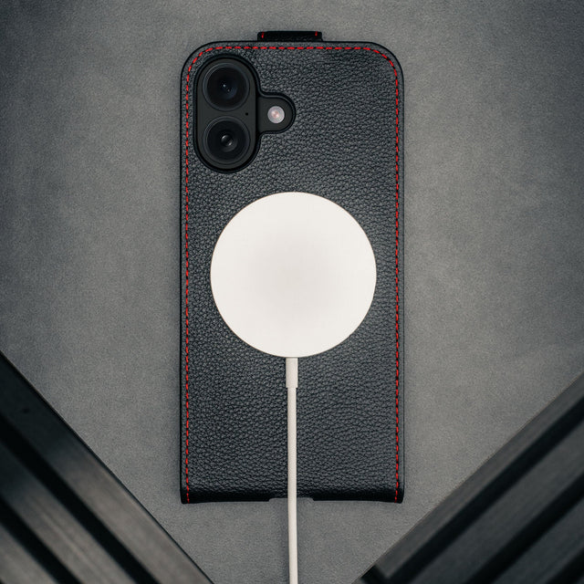 MagSafe charger attached to the Black with Red Stitching Leather Flip Case for iPhone 17