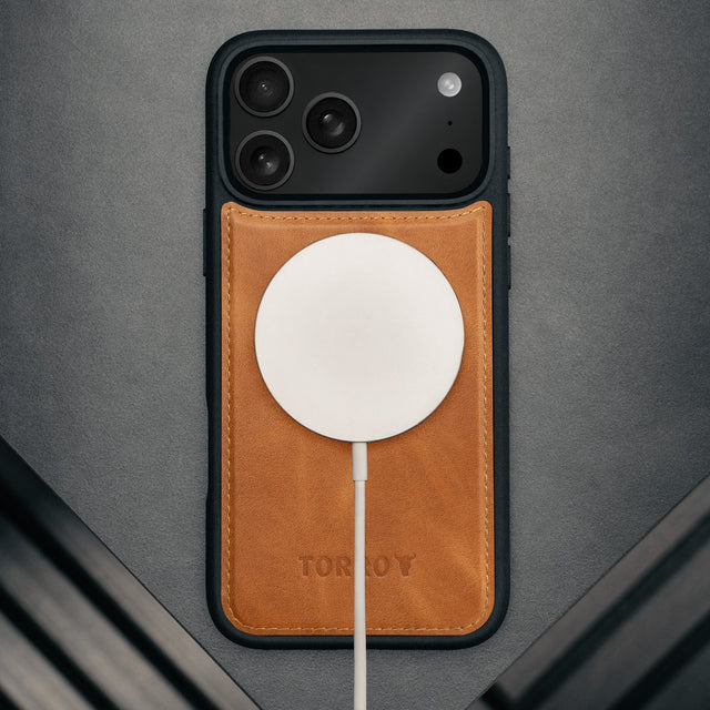 MagSafe charger attached to the Black Leather Detachable Case for iPhone 17 Pro Max