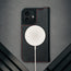 MagSafe charger attached to the Black (with Red Detail) Leather Case for iPhone 17